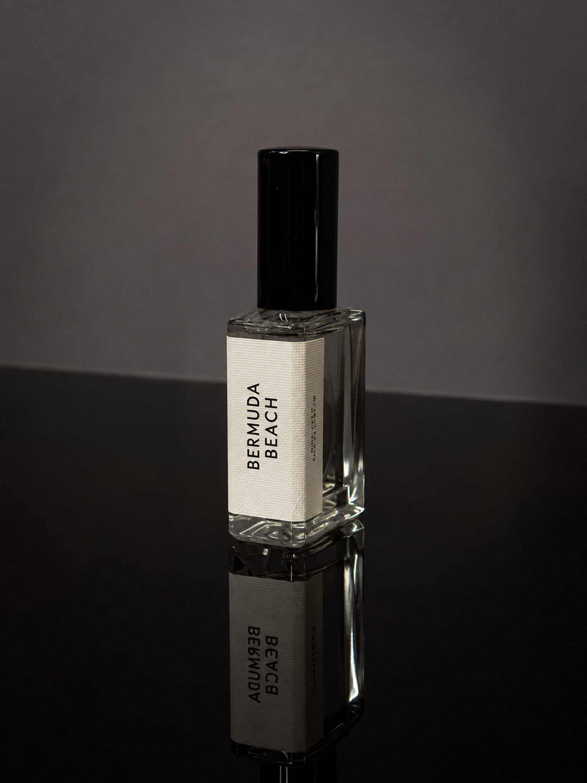 Bermuda Beach Wearable Fragrance in a clear rectangular glass bottle with a black cap and minimalist white label