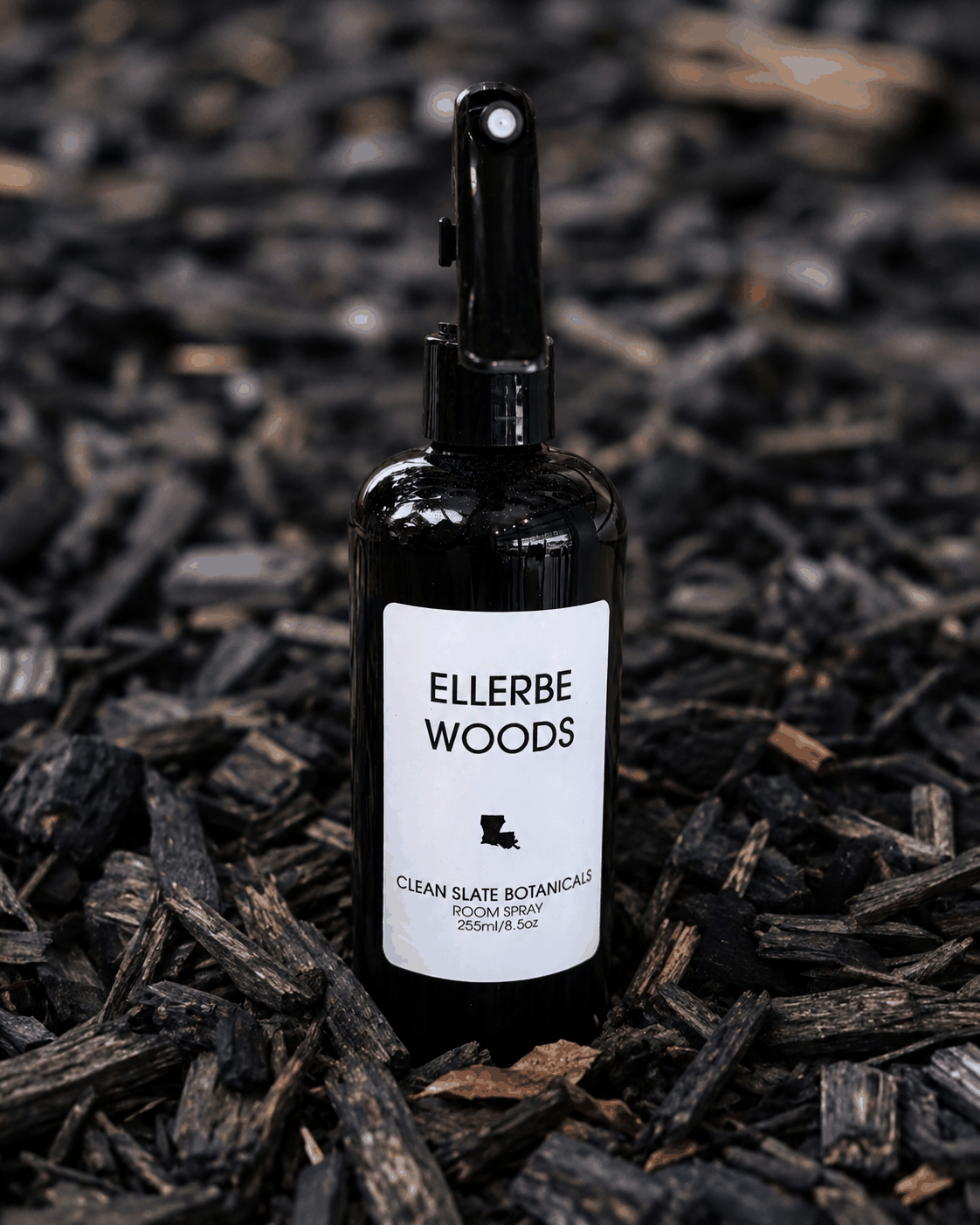 Ellerbe Woods Room Spray in a black glass bottle with a white label and black fine-mist sprayer
