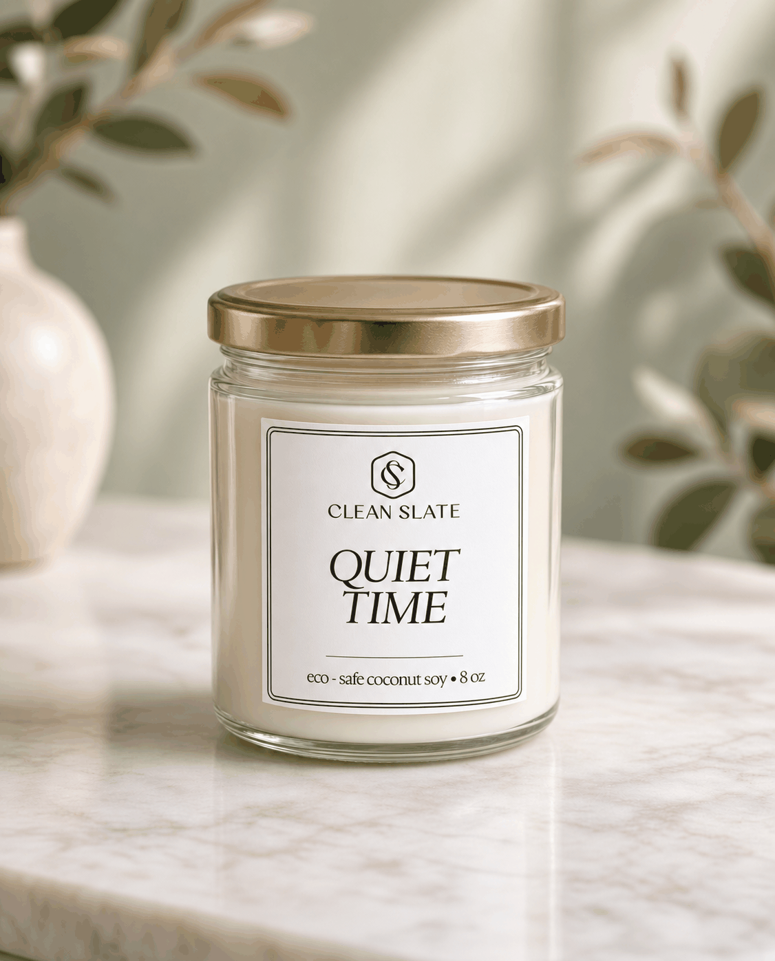 Quiet Time Core Candle in a clear glass jar with a gold metal lid and minimalist white label with black text